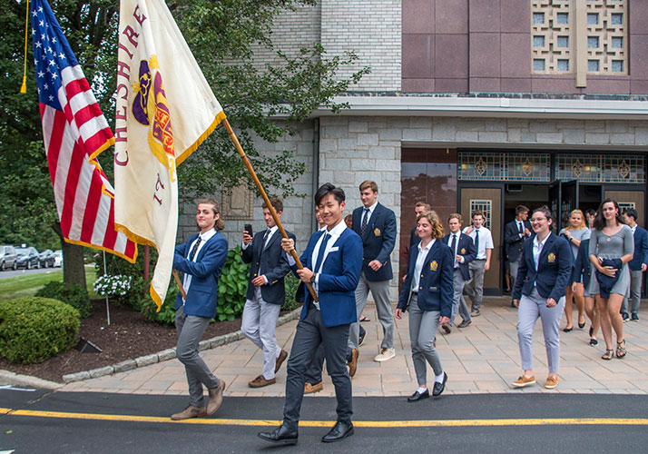 Photo of students holding flags. Links to Gifts by Will